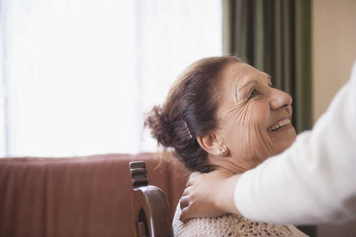 Woman sitting on a chair smiling at someone